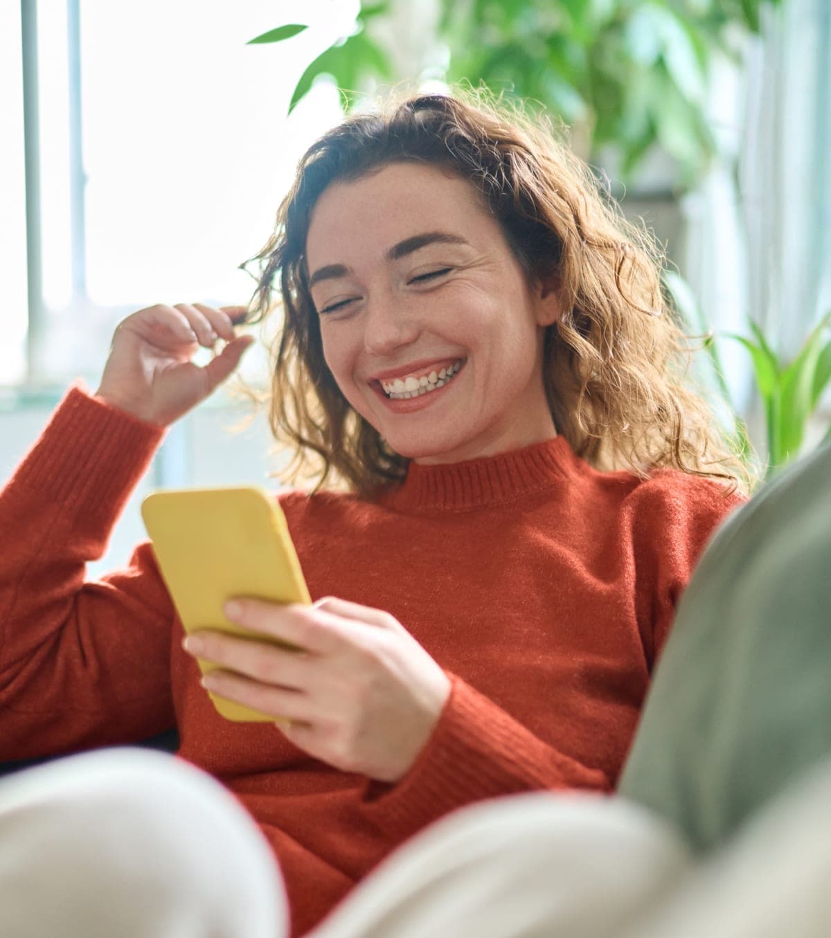 A student smiling at her phone